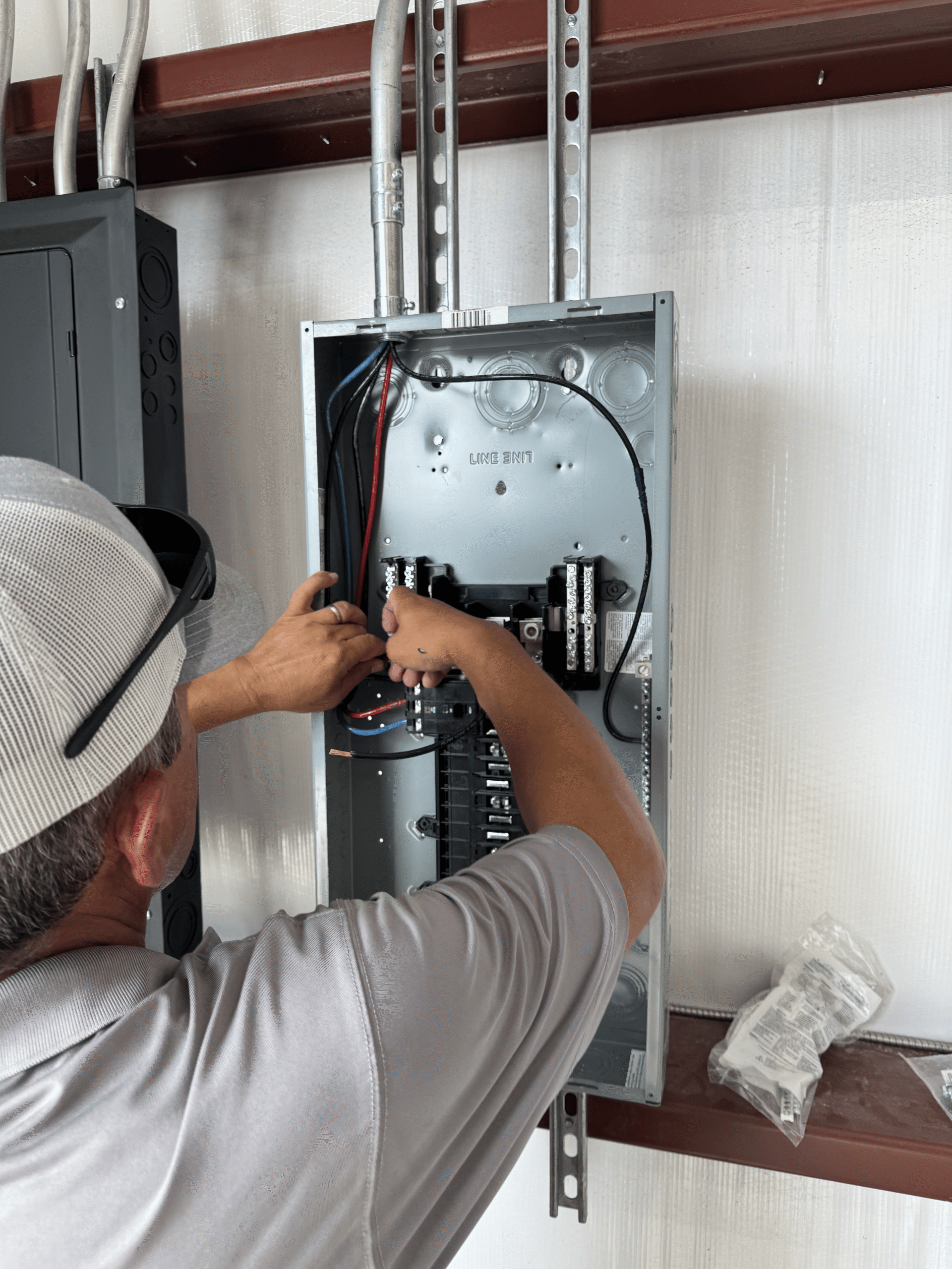Electrician installing a new electrical panel during a residential build in Liberty Hill, TX